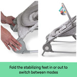 Light gray tweed 2-in-1 Bouncer & Rocker with foldable stabilizing feet for mode switching and removable toy bar.
