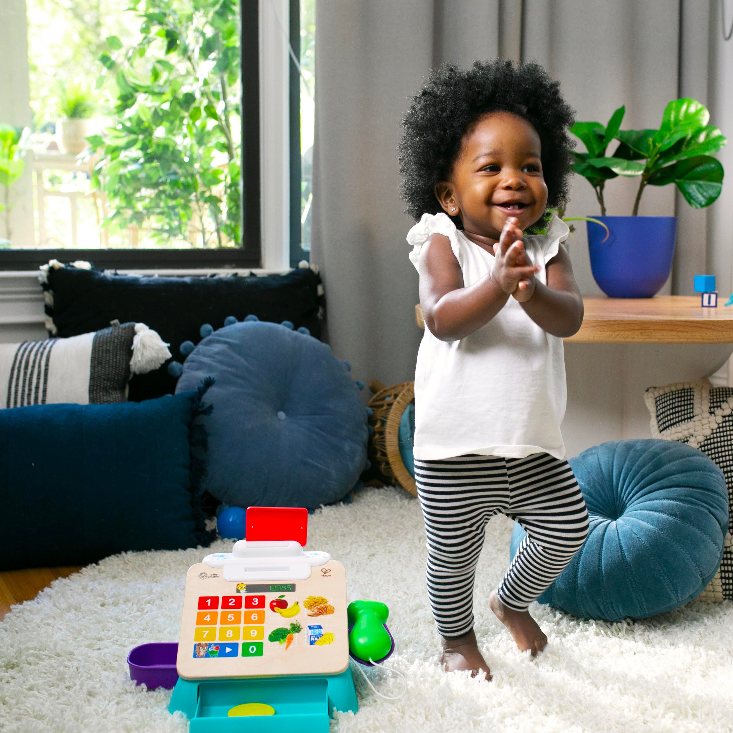 baby playing with wooden calculator