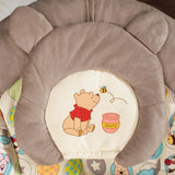 Winnie the Pooh baby bouncer seat with cushioned headrest and playful honey pot design