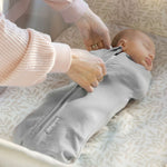 Newborn baby peacefully sleeping in a gray Ingenuity Velboa Pod swaddle with zipper closure for secure comfort and easy diaper changes