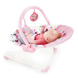 Minnie Mouse Spotty Dotty Vibrating Bouncer for Babies with pink polka dots and Minnie-themed toys.