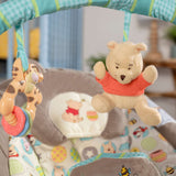 Winnie the Pooh baby bouncer seat with hanging toys and cushioned fabric seat