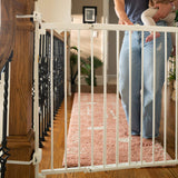 White metal baby and pet gate installed on staircase, easy walk-through, no-threshold design, The Stairway+ 46W Series.