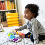 baby playing with a glow & discover light bar activity station