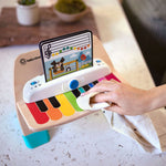 Baby Einstein Magic Touch Piano Musical Toy with color-coded keys and music sheets.