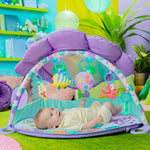 MERMAID Twinkle Trove Lights & Music Activity Gym with seashell canopy and baby on colorful mat.