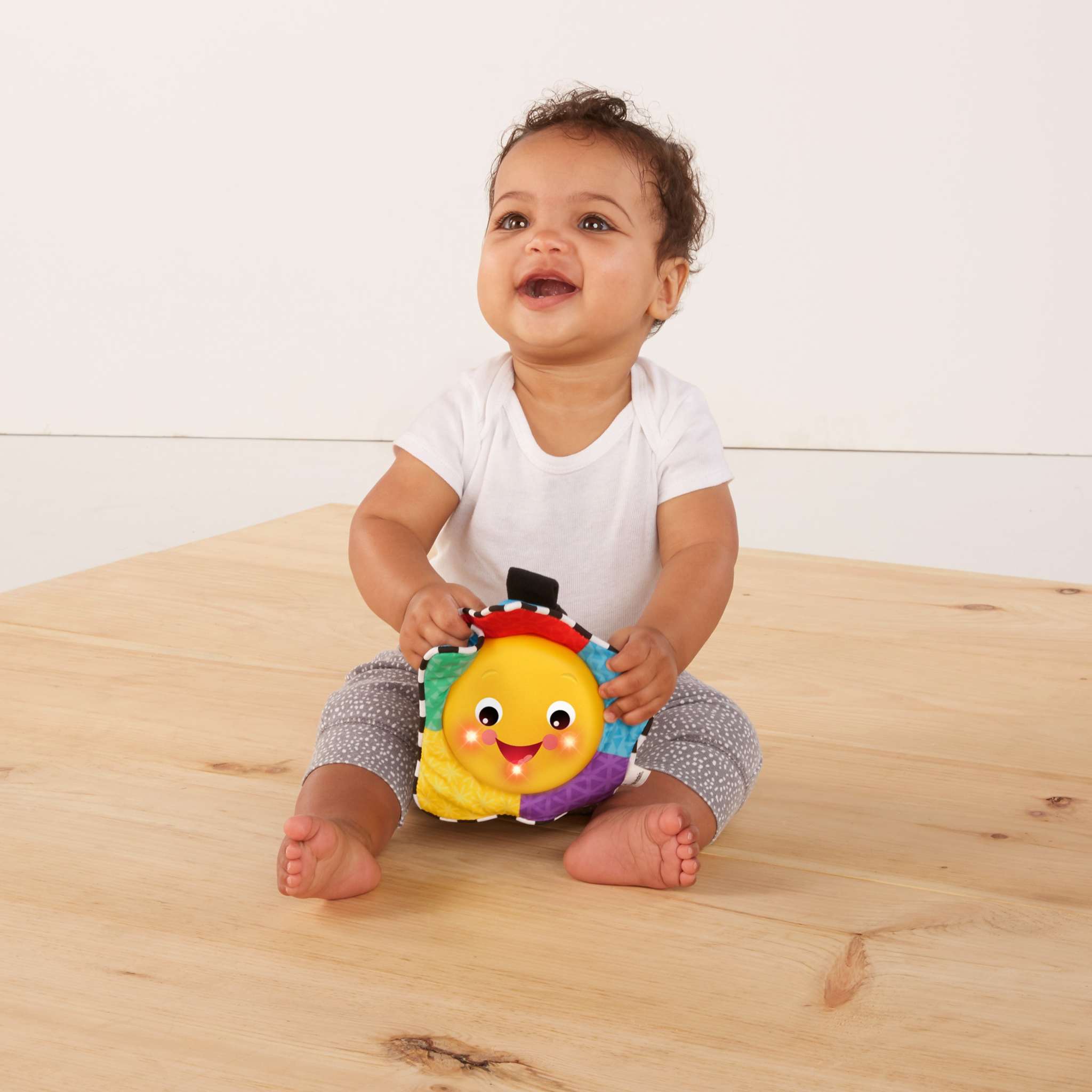 baby playing with a star bright symphony take-along toy