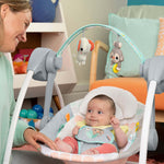 Bright Starts Whimsical Wild Portable Swing with toy bar, soothing melodies, and adjustable harness.