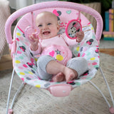 Minnie Mouse Spotty Dotty Vibrating Bouncer for Babies with toy bar and polka-dotted design.