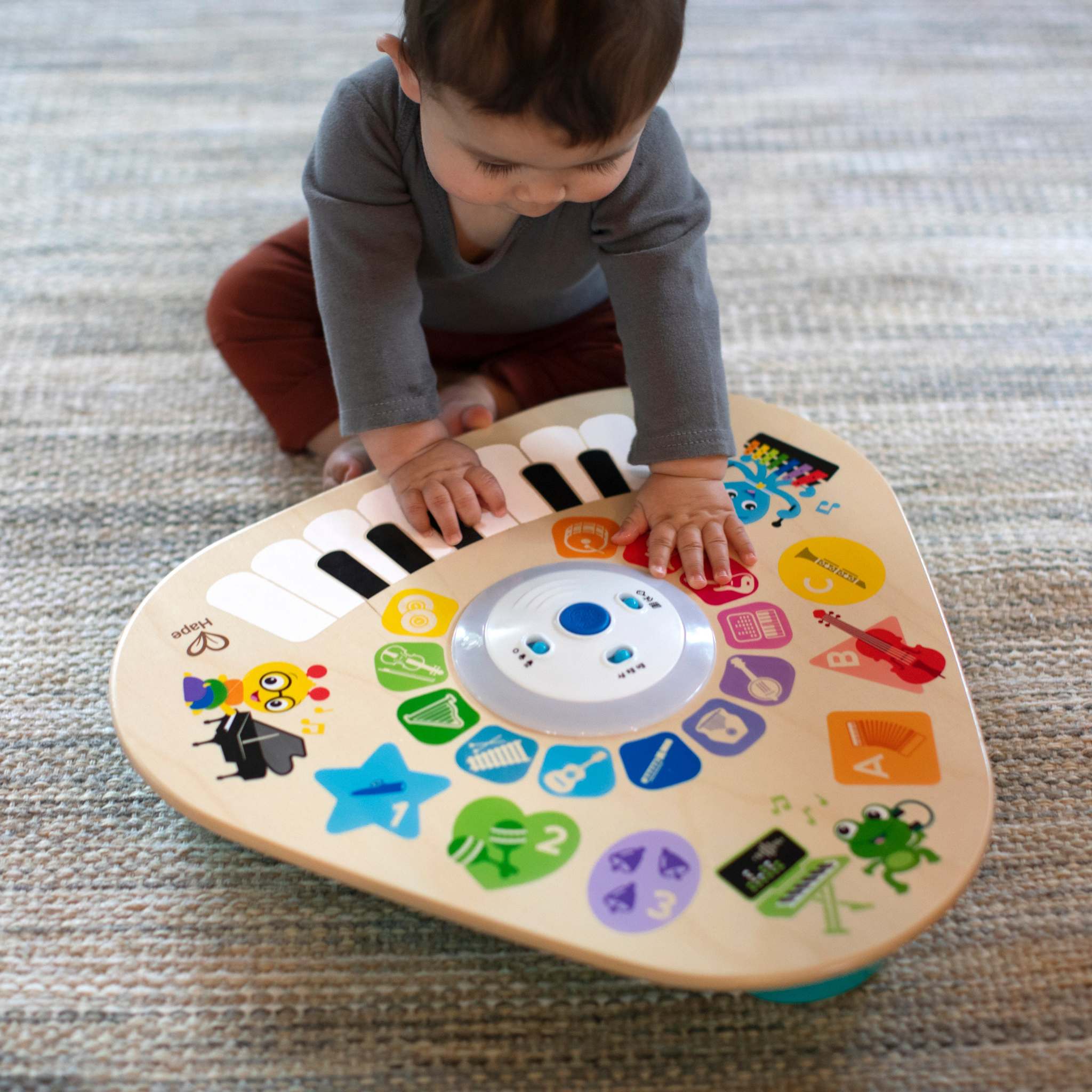 baby playing with clever composer tune table magic touch activity toy