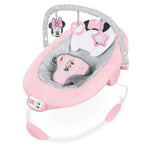 MINNIE MOUSE Rosy Skies ™ Comfy Bouncer with pink and gray design, plush pillow, Minnie Mouse ears, bow, 3-point harness, and playtime toys for infants.