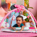 MINNIE MOUSE Forever Besties Activity Gym with baby on pink mat, colorful toy bars, and hanging toys.