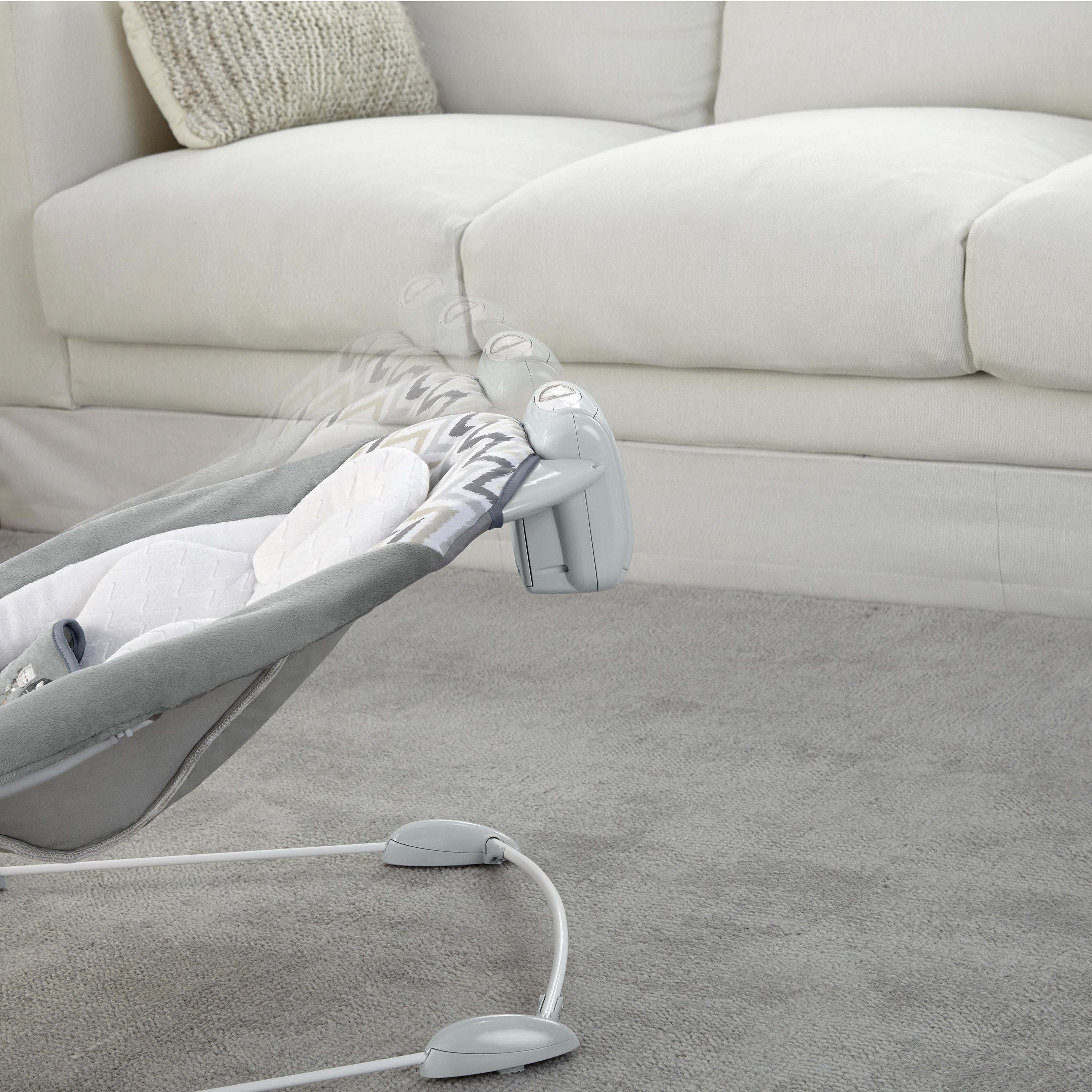 Ingenuity SmartBounce Automatic Bouncer - Braden with plush seat and toy bar in living room setting.