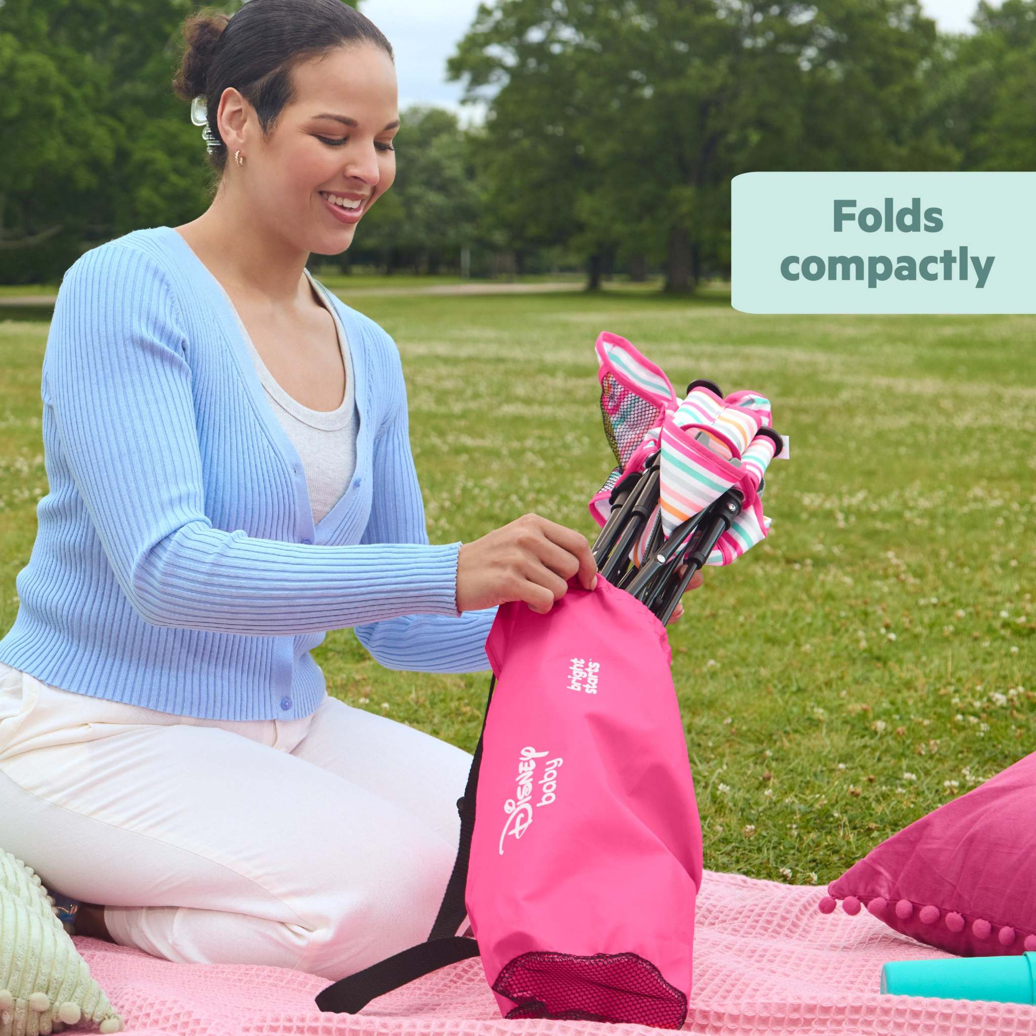 MINNIE MOUSE Pop ‘N Sit™ Portable Booster Seat, compactly folded, ideal for travel and outdoor use, featuring a Disney design.