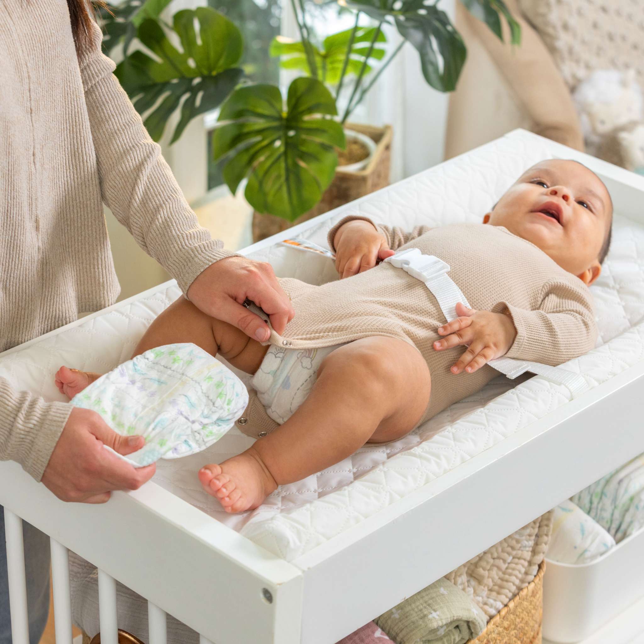 baby using a summer by ingenuity contoured changing pad