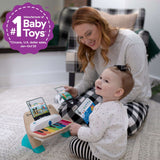 Baby playing with Magic Touch Piano musical toy, promoting creativity and music appreciation.