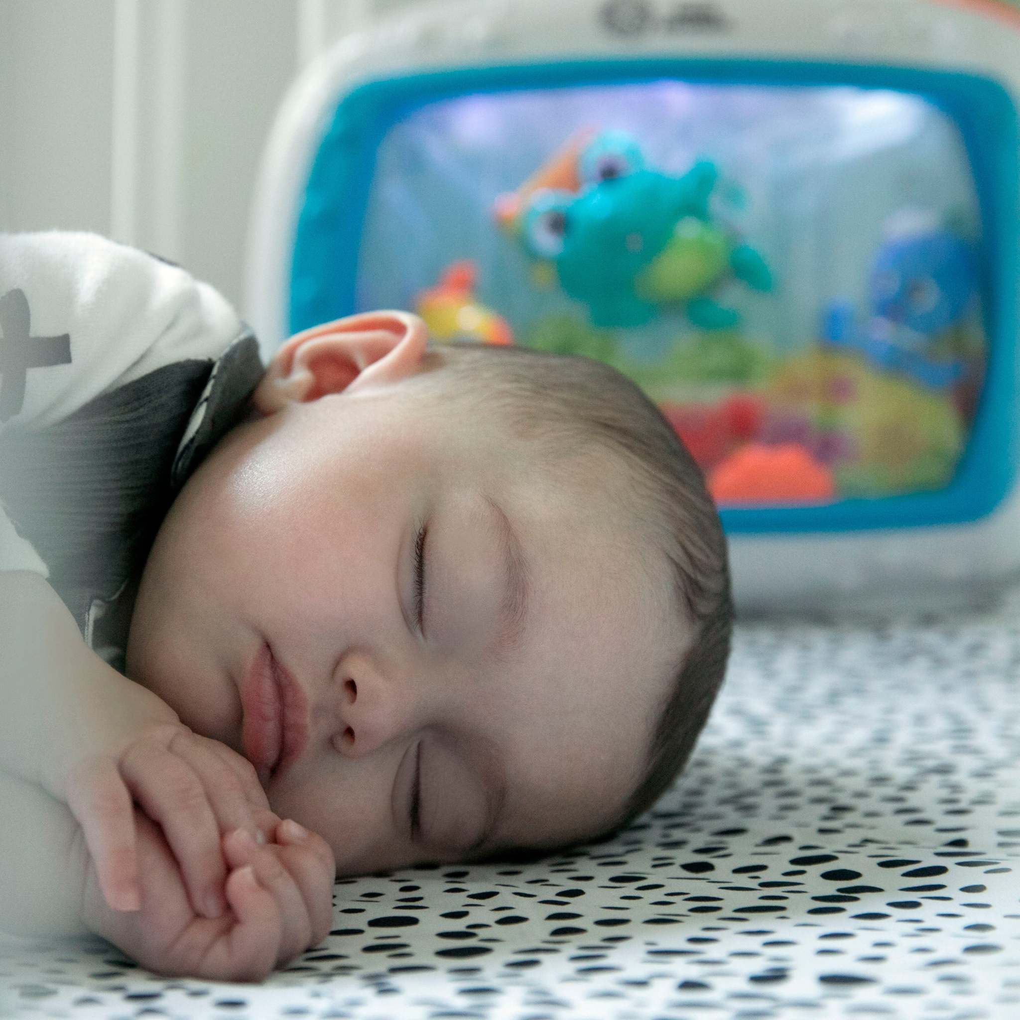 Baby sleeping peacefully in cozy bassinet with soothing sleep essentials