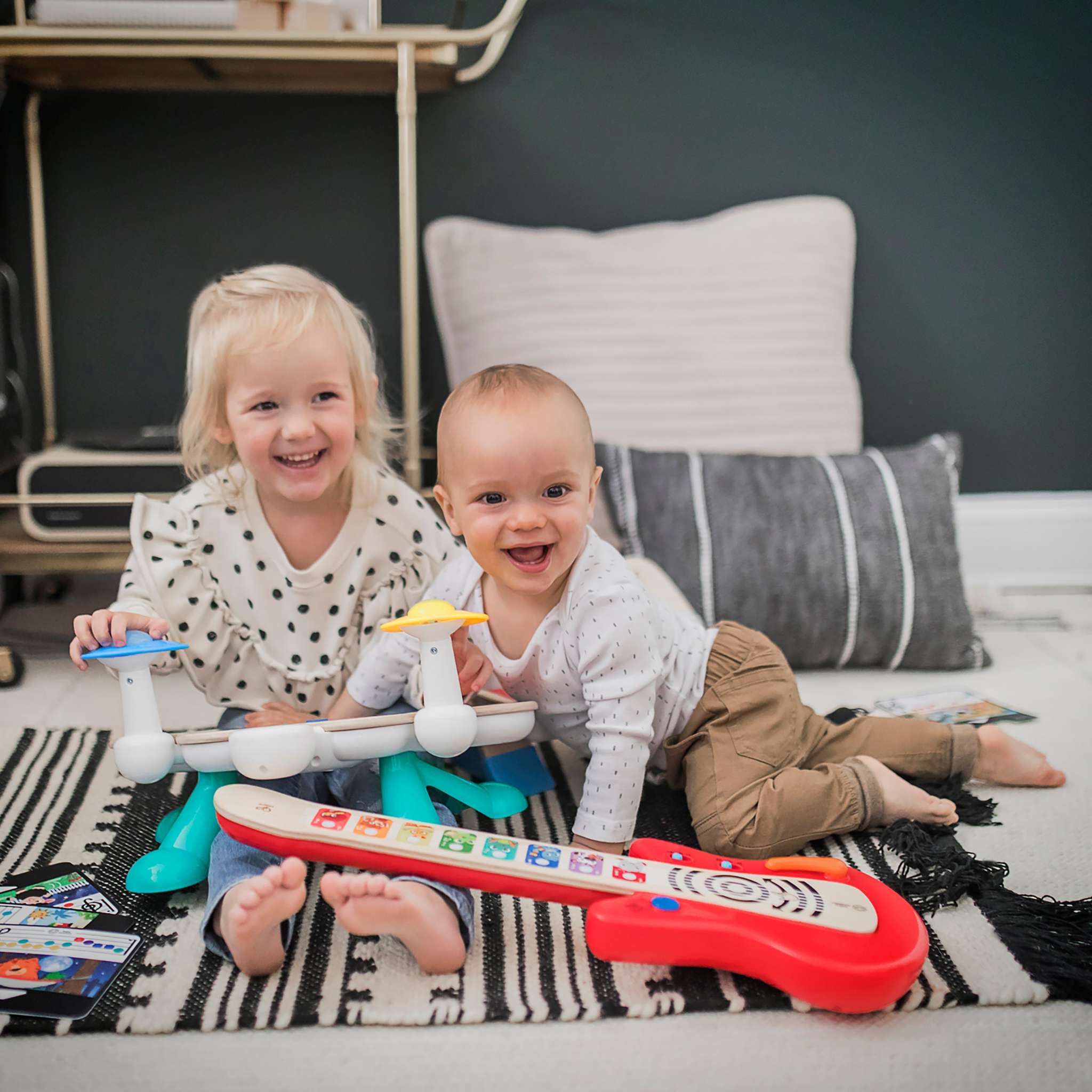 Baby playing with social-emotional development toys from Baby Einstein, Bright Starts, and Ingenuity promoting emotional growth and bonding