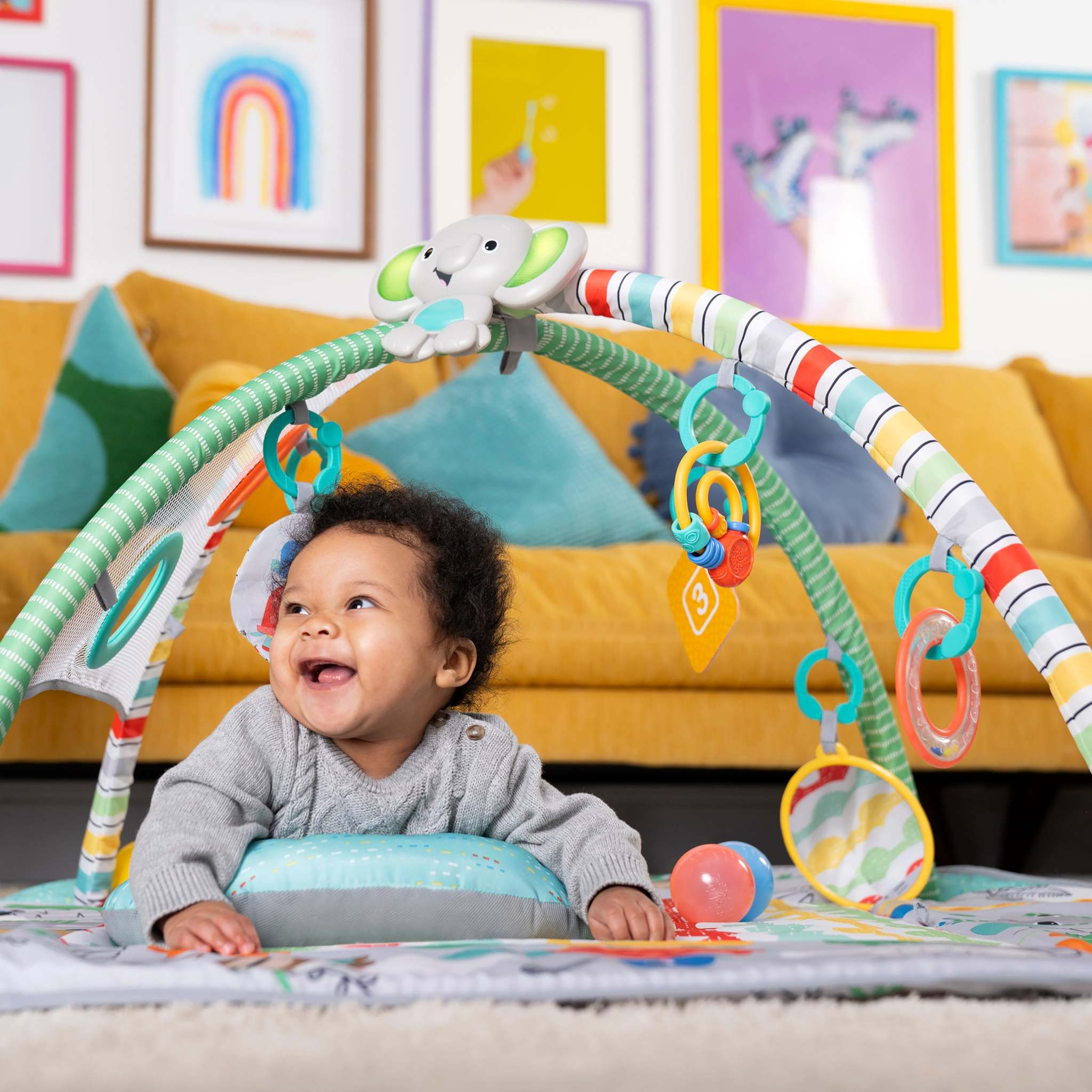 Colorful play gym and mat with hanging toys for baby sensory and motor skill development