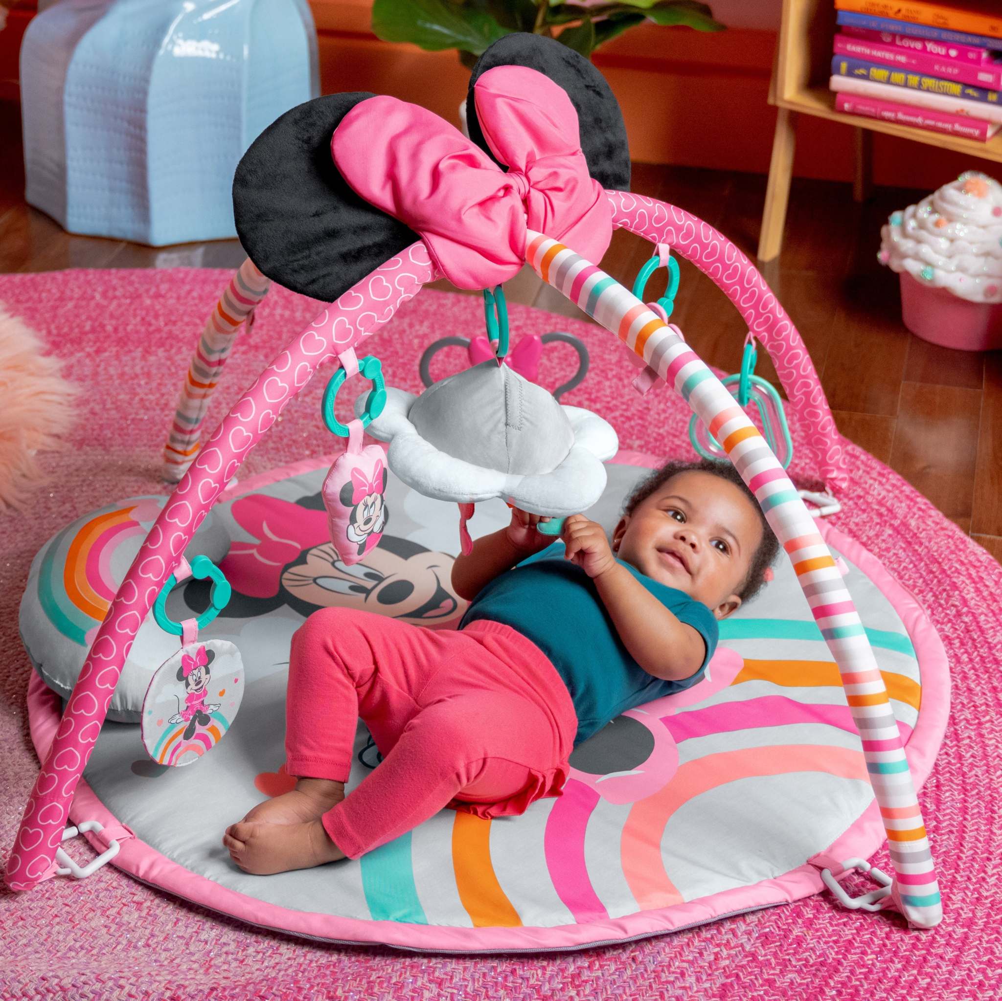 Colorful baby activity gym with soft textures and hanging toys for sensory development