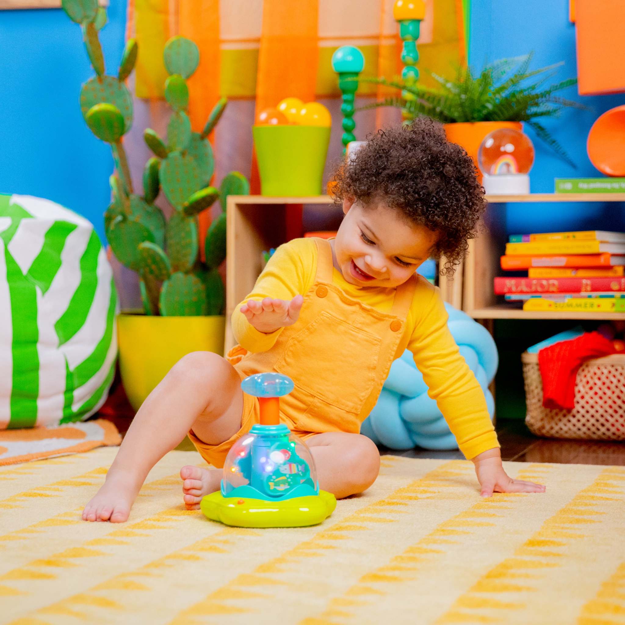 Press & Glow Spinner baby toy with spinning star, lights, and melodies for infants 6-36 months to encourage fine motor skills and cause-effect learning