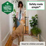 Ingenuity The Doorway 48W Series bronze metal pet and baby safety gate installed in a doorway with arch top and pressure mount system