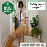 Ingenuity The Doorway 48W Series bronze metal pet and baby safety gate installed in a doorway with arch top and pressure mount system