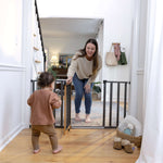 Ingenuity The Thruway 60XW Series pet and baby gate with honey oak frame and geometric design, fits 30-60 inch openings