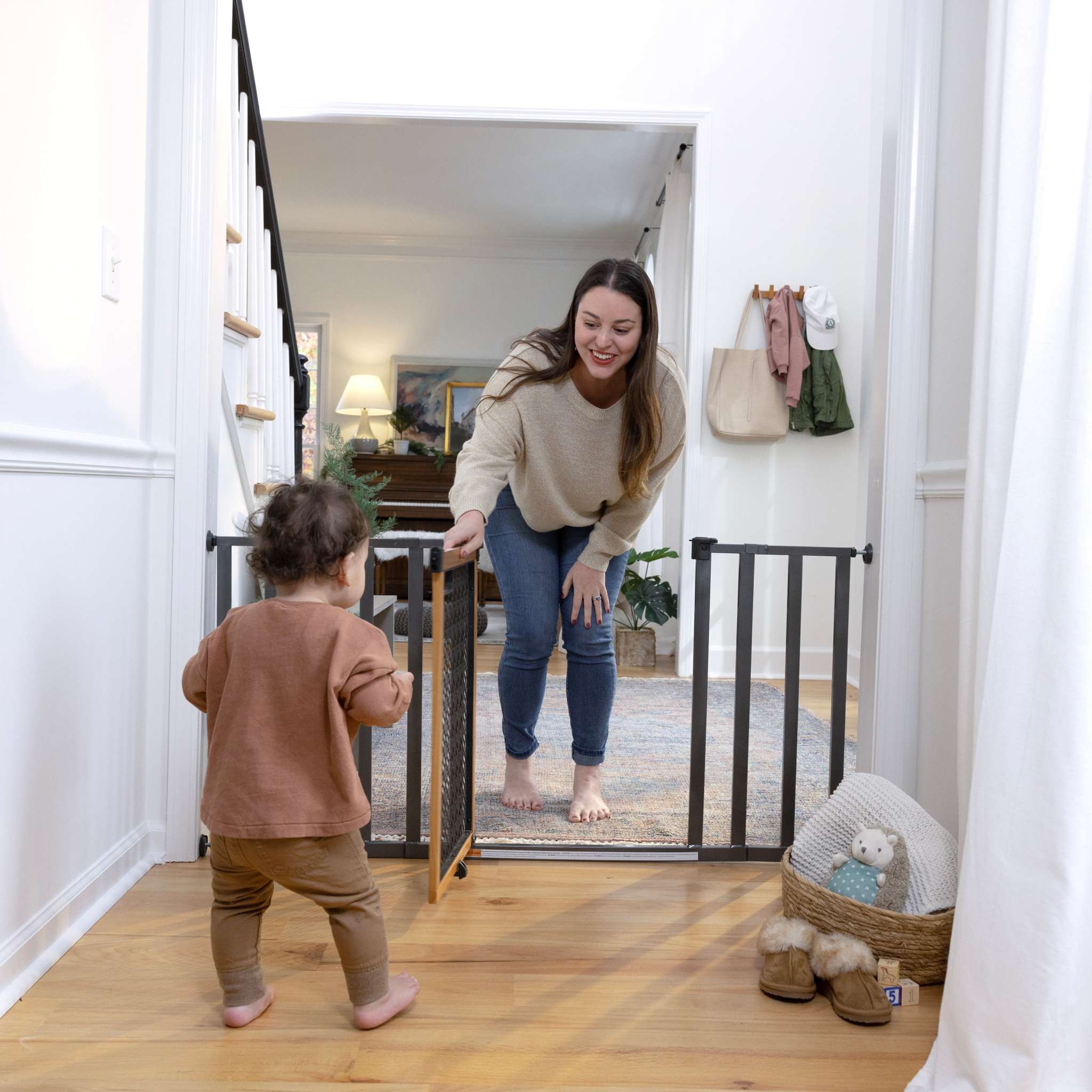 Ingenuity The Thruway 60XW Series pet and baby gate with honey oak frame and geometric design, fits 30-60 inch openings