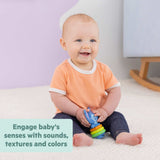 baby playing with Disney Baby Stitch Tropical Treasures toy set colorful rings and blue Stitch figure