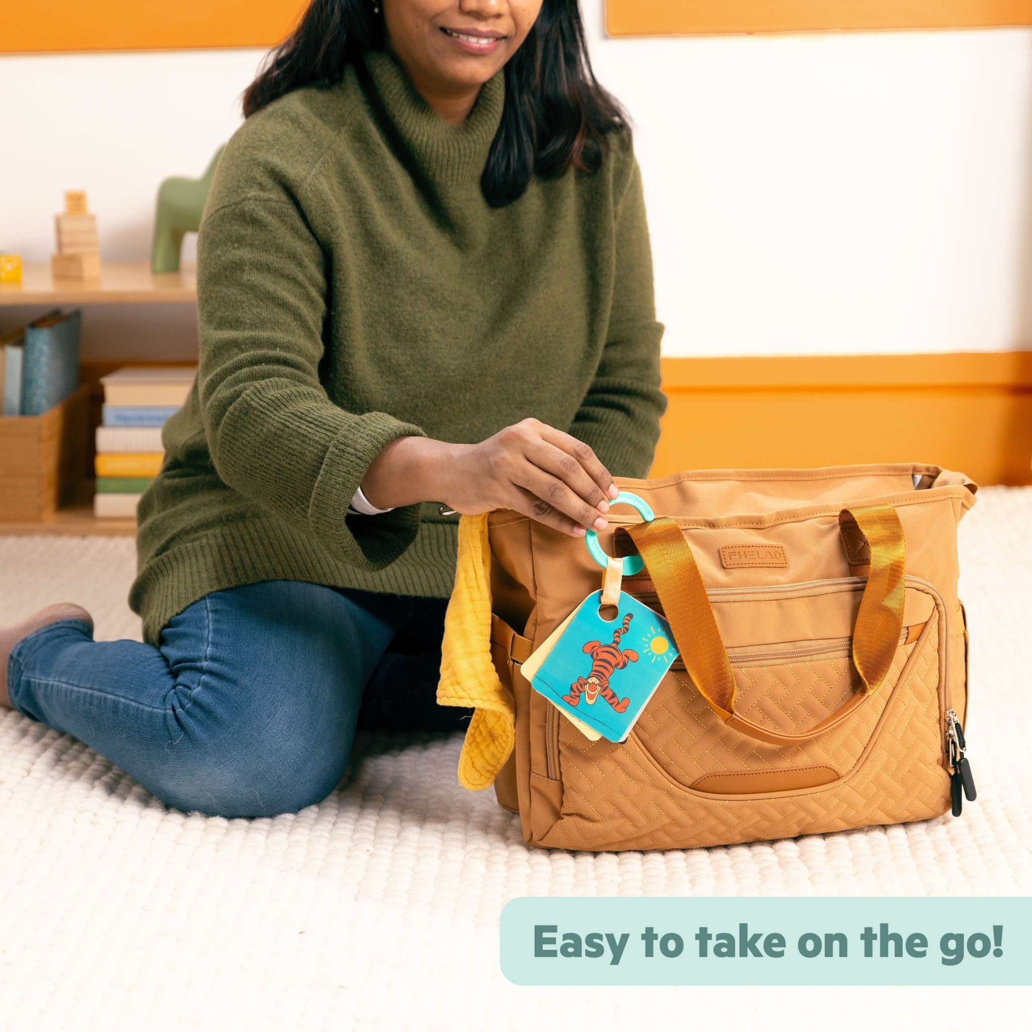 Disney Baby Winnie the Pooh Silly Ole Bundle sensory toy set attached to diaper bag for on-the-go play