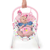 Minnie Mouse Spotty Dotty vibrating baby bouncer with pink polka dots and two hanging toys