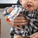Baby holding Baby Einstein Jingle & Jam tambourine toy with colorful rings and music buttons
