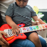 child playing with together in tune guitar connected magic touch guitar