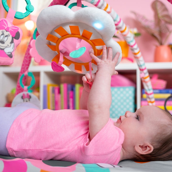 baby playing with minnie mouse forever besties activity gym