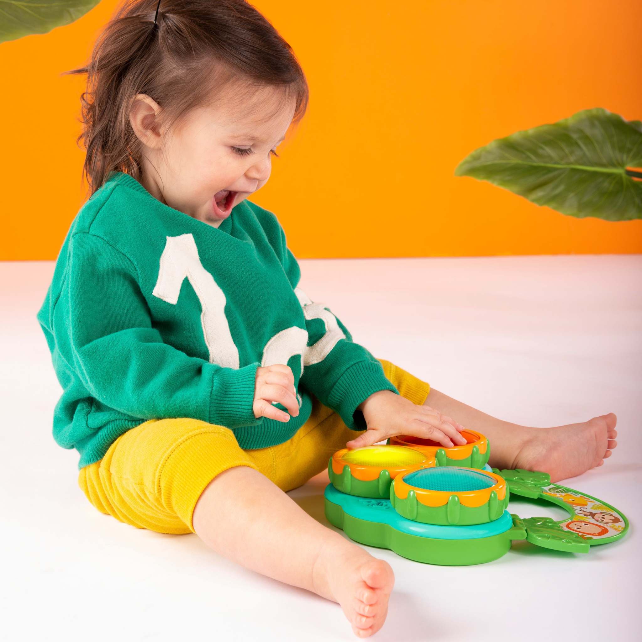 child playing with a safari beats musical toy