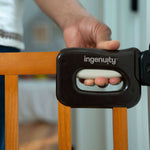 Ingenuity The Stairway 48W Series brown wood safety gate for stairs and hallways with locking indicator and comfort grip handle