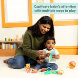 Mother playing with baby using Disney Baby Winnie the Pooh sensory toy set on the floor