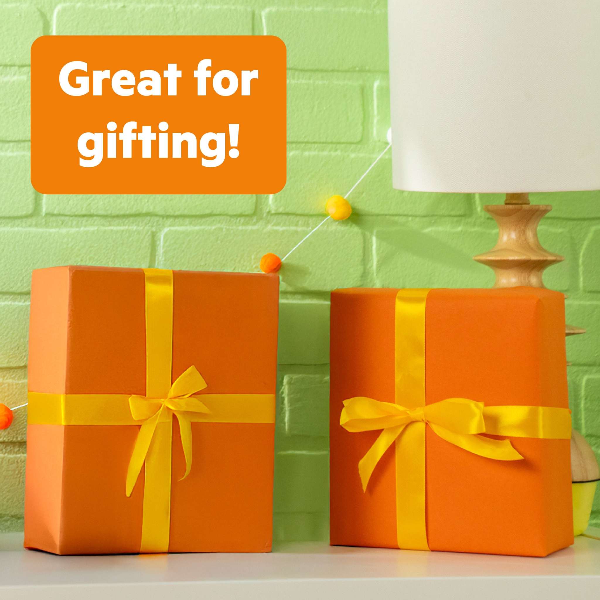 Bright Starts Safari Sounds Gift Set wrapped as colorful orange baby shower gifts with yellow ribbons