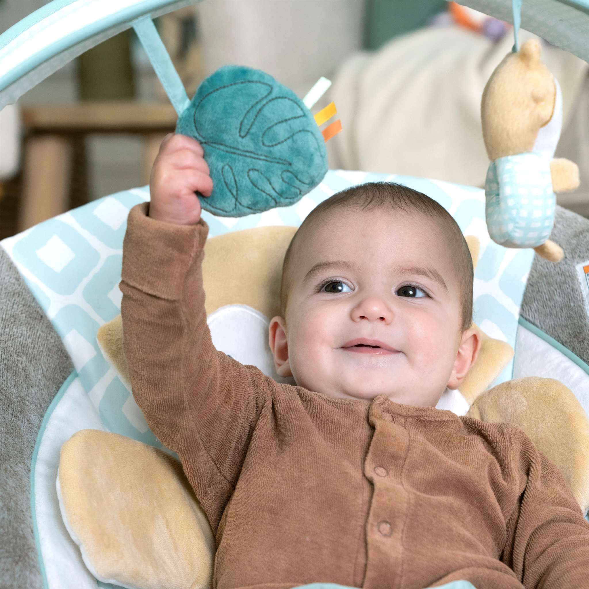 baby in a inlighten bouncer - kitt