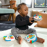 baby playing with a small symphony 3-piece musical toy set