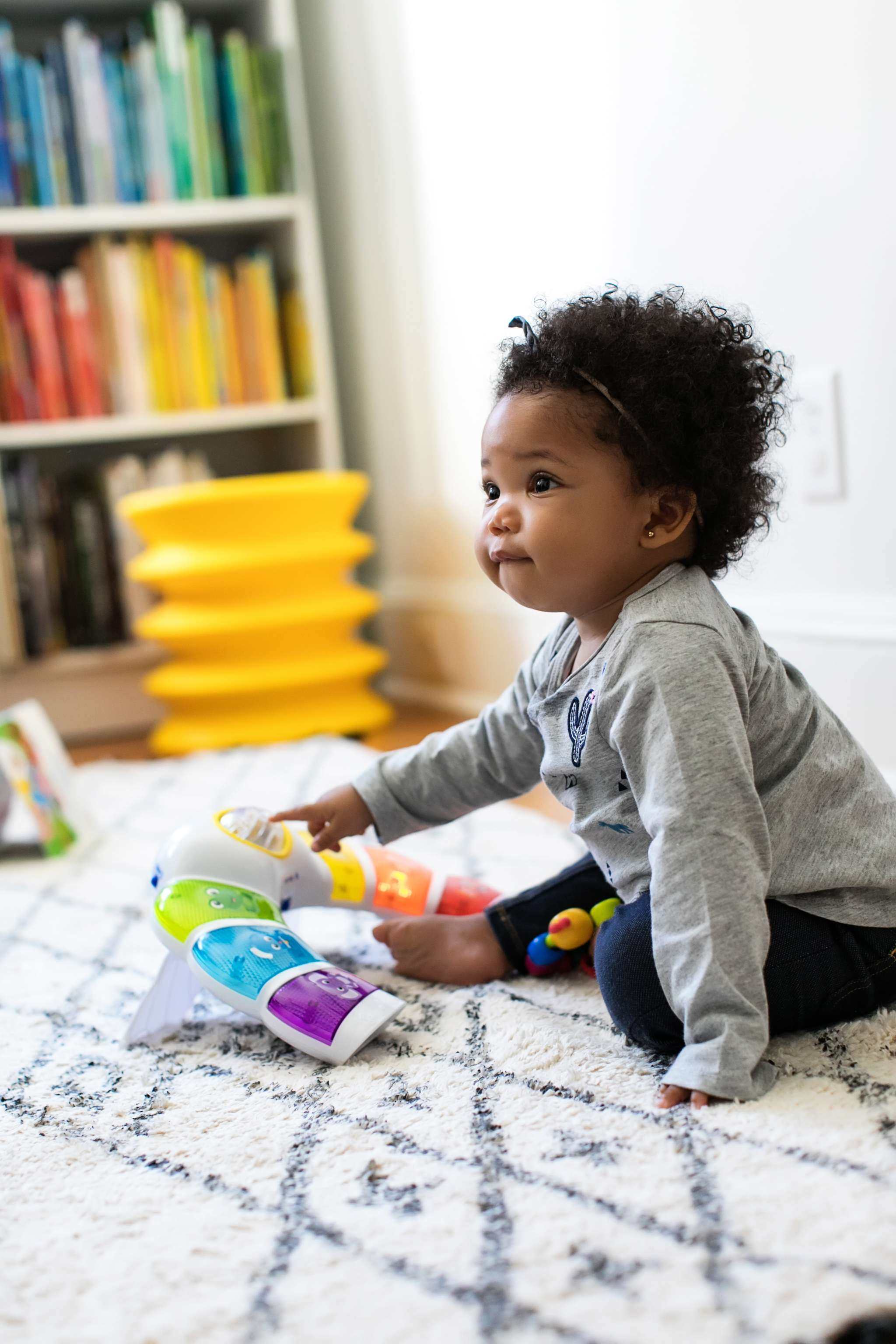 baby playing with a glow & discover light bar activity station