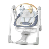 Ingenuity Swing ‘n Go portable baby swing with removable toy bar and 6-speed settings in chambray color