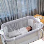 Ingenuity Dream Hero 3-in-1 gray co-sleeping bassinet with breathable mesh sides and locking wheels