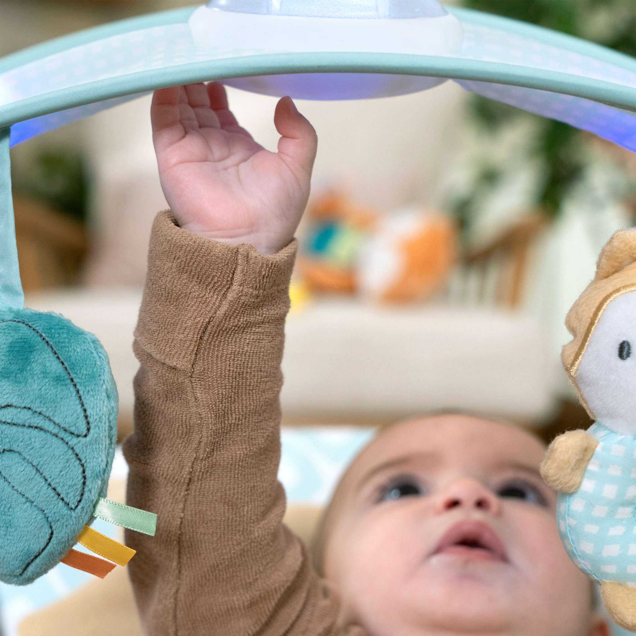 Ingenuity InLighten baby bouncer seat with light-up toy bar and cozy fox bolster