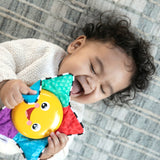 baby playing with a star bright symphony take-along toy