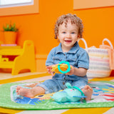 baby in a wild wiggles foldaway activity gym