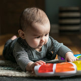 baby playing with a glow & discover light bar activity station