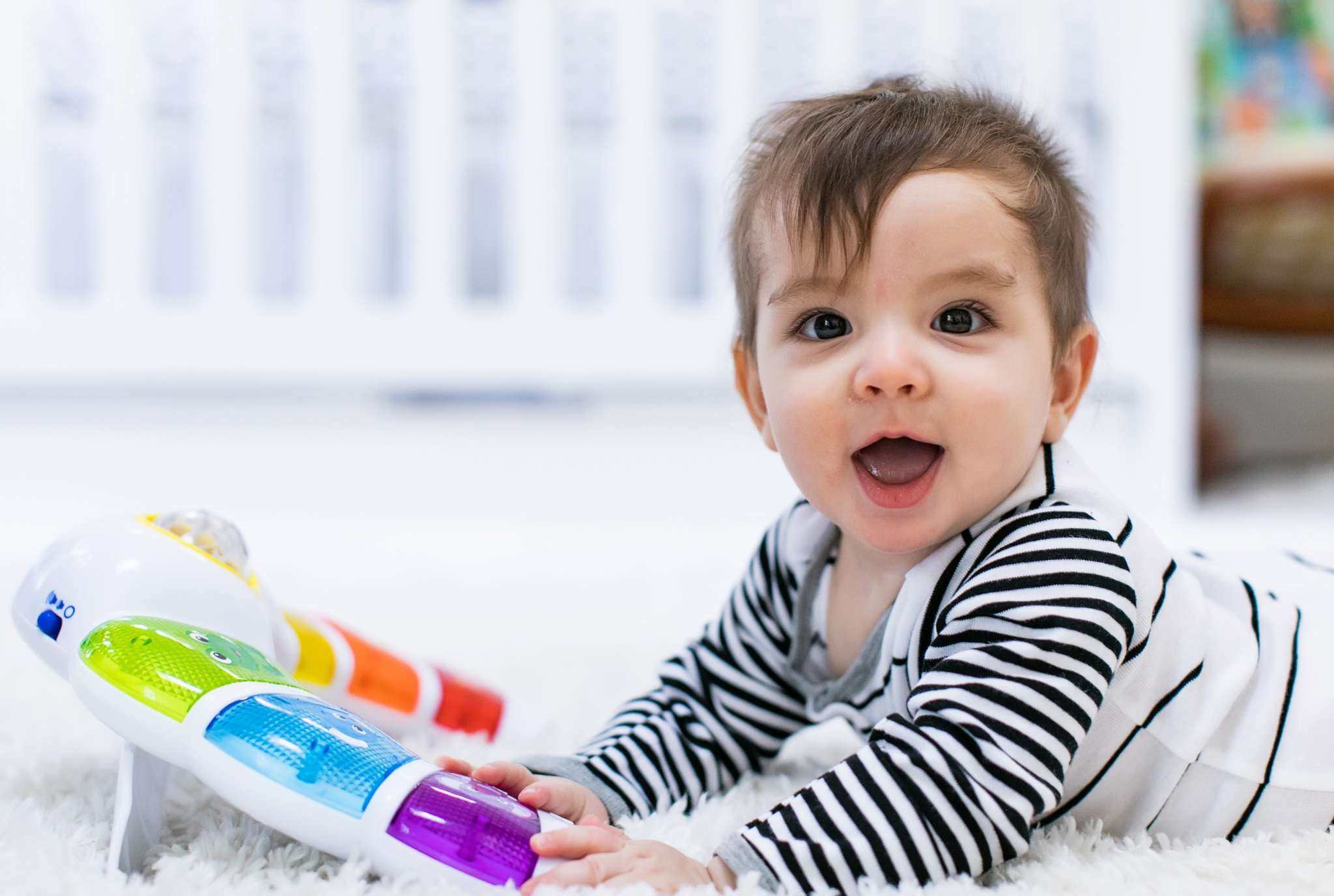 baby playing with a glow & discover light bar activity station