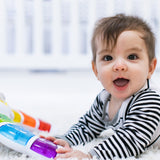 baby playing with a glow & discover light bar activity station